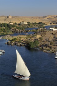 Egypt, Upper Egypt, Nubia, Nile Valley, Aswan, Elephantine Island on the right with archeological excavations site of Satis and Khnoum temples and the Agha Khan mausoleum in the background on the western bank