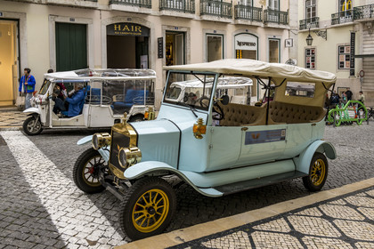 Portugal, Lisbon, Bairro Alto, tourist transport car, an electric replica of a vintage car and Tuk Tuk