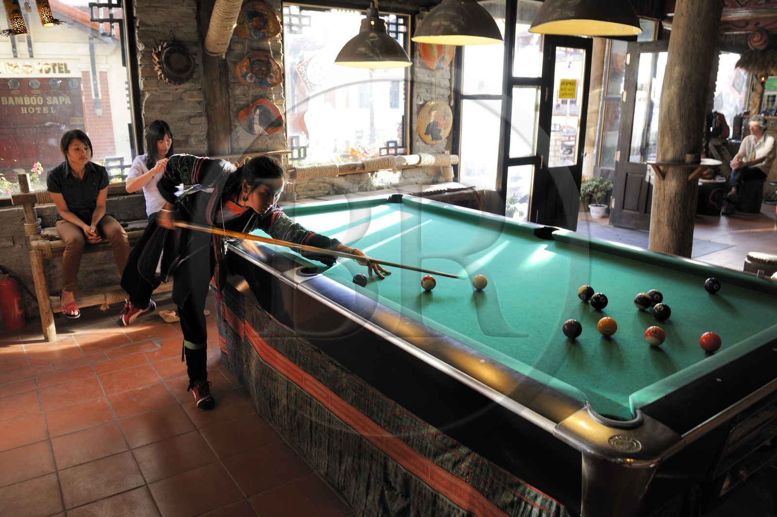 Vietnam, Lao Cai province, city of Sapa, young women from Black Hmong minority group playing pool
