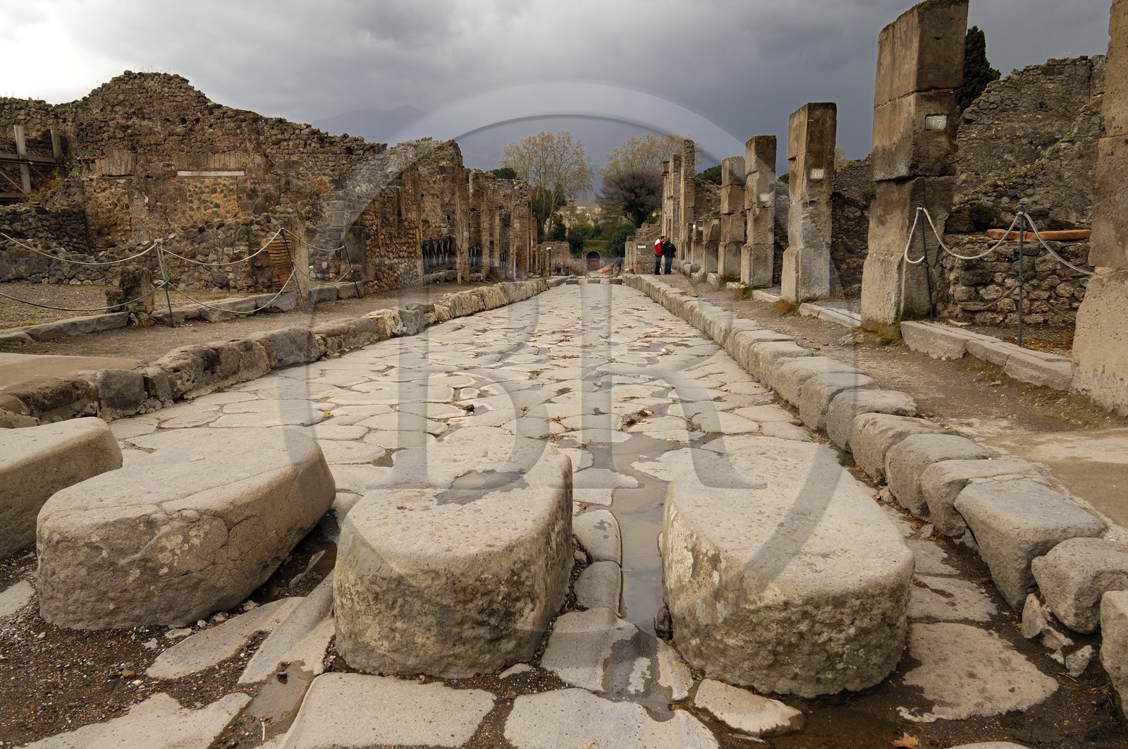 Italy, Campania, Pompei, archeological site listed as World Heritage by UNESCO, old paved street of the city, pedestrian crossing