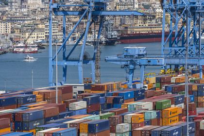 Italy, Liguria, Genoa, the container terminal of the commercial port and the city in the background, handling gantries