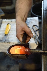 France, Moselle, Meisenthal, Centre international d'Art verrier (CIAV) (international glass centre), the blowing workshop, crafting a Christmas ball, the prompter regulates the mass at home plate while performing a continuous rotation of his cane