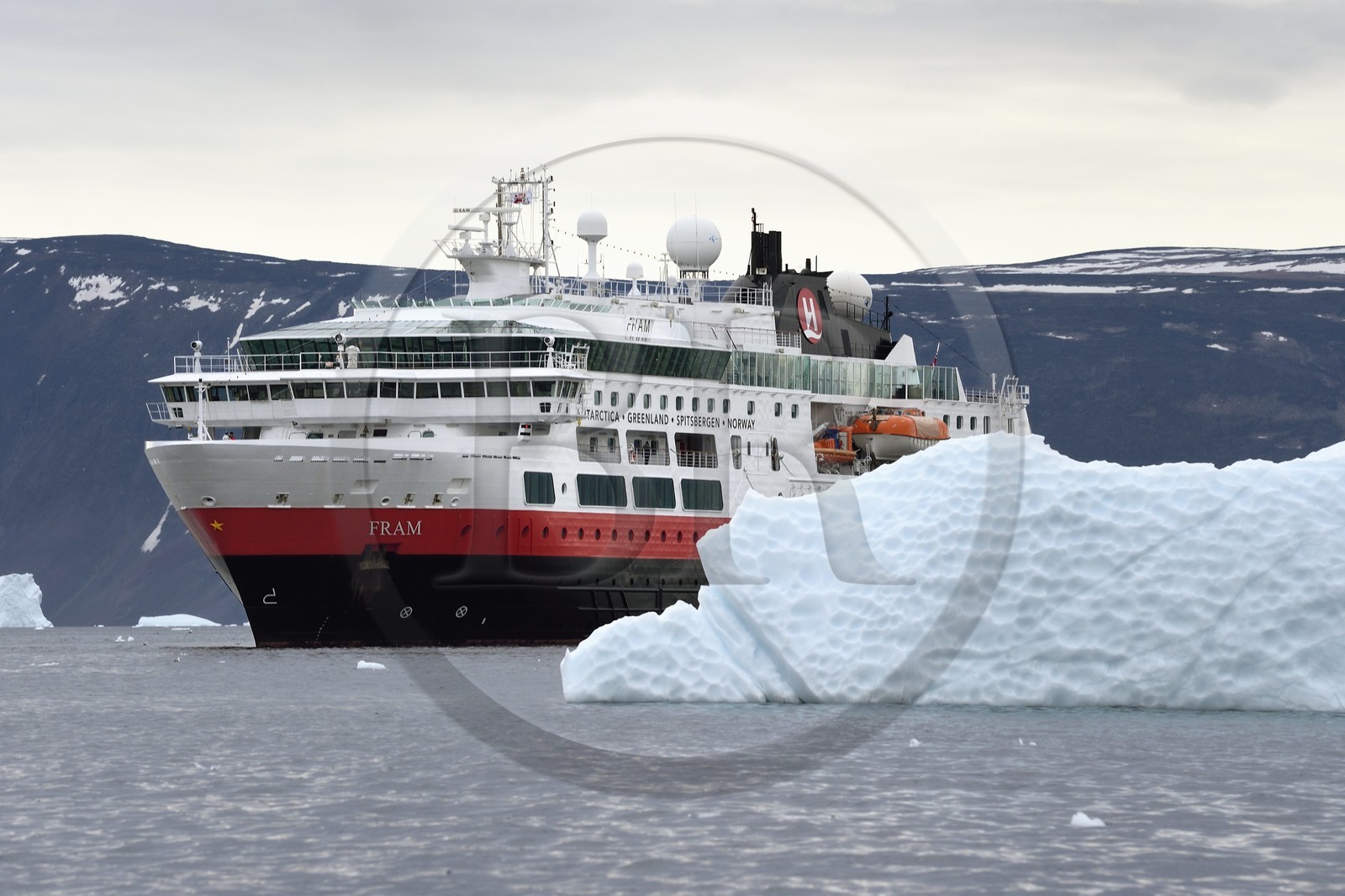 Greenland, North West coast, Baffin Sea, Inglefield Fjord towards Qaanaaq, iceberg and the MS Fram cruse ship from Hurtigruten