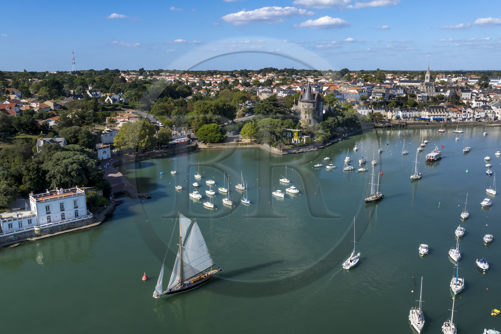 France, Loire Atlantique, Pornic, the Pen Duick sailboat followed by the Pen Duick II leaving the port under sail, the Saint-Gilles church and the castle in the background (aerial view)