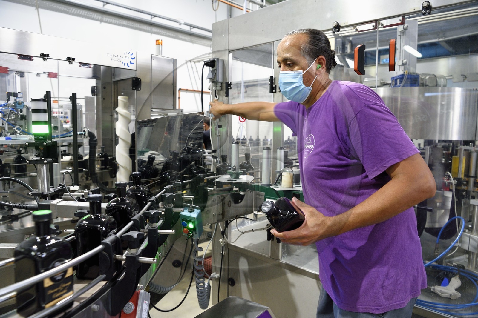 France, Reunion island (French overseas department), Saint Pierre, estate of the Isautier distillery, bottling and labeling plant, bottling line of 70cl of arranged rum
