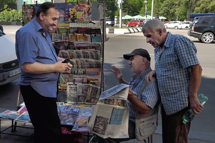 Georgia, Tbilisi, Merab Kostava street, newspaper seller