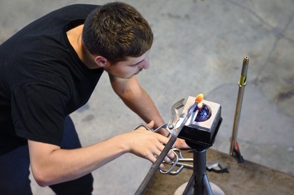France, Moselle, Meisenthal, Centre international d'Art verrier (CIAV) (international glass centre), the blowing workshop, crafting a Christmas ball, installation of the pellet for the creation of the glass hook