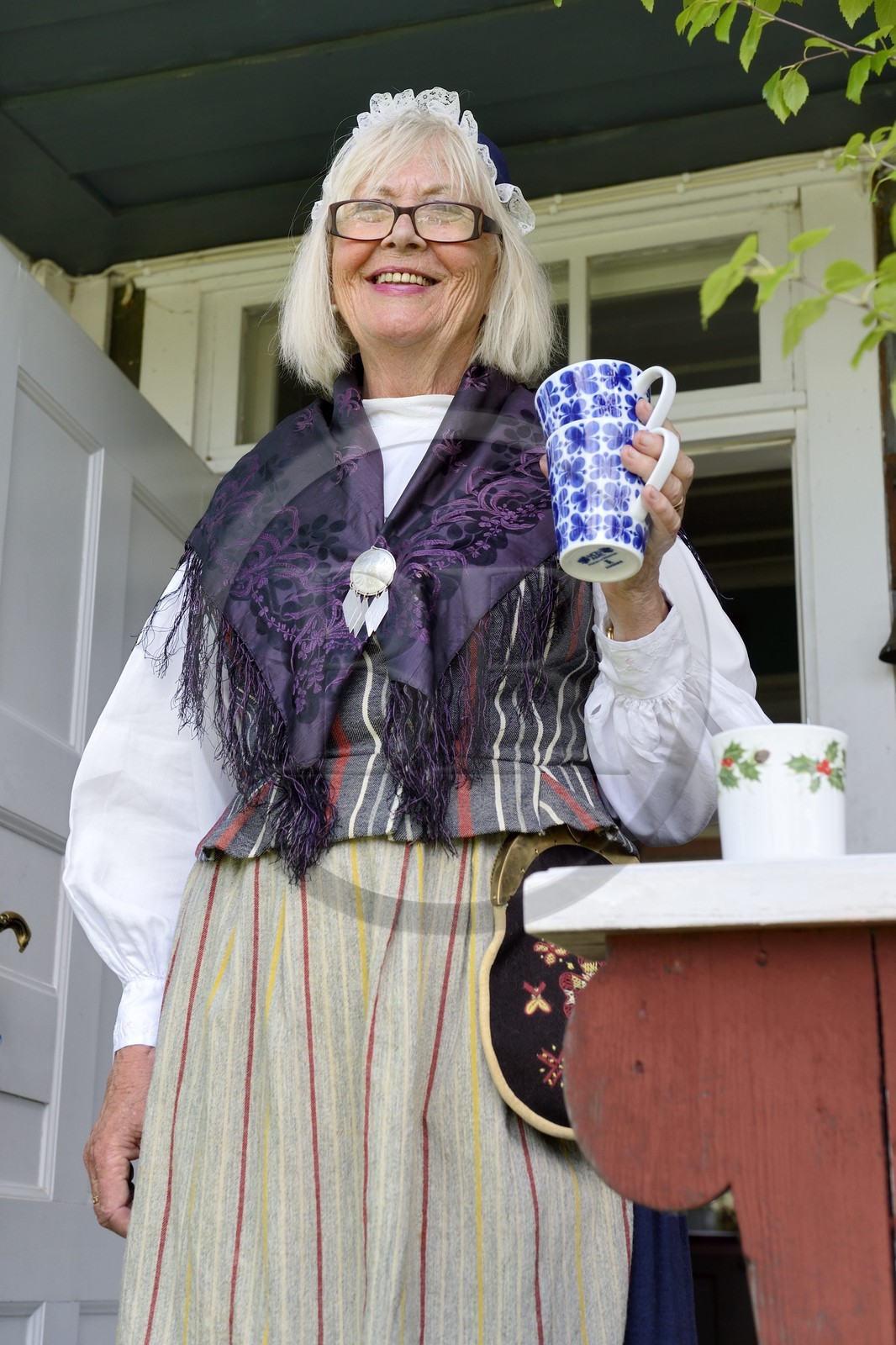 Sweden, Dalarna County, Leksand area, woman in traditional costume for the Midsummer celebrations in the tiny hamlet of Sunnanäng