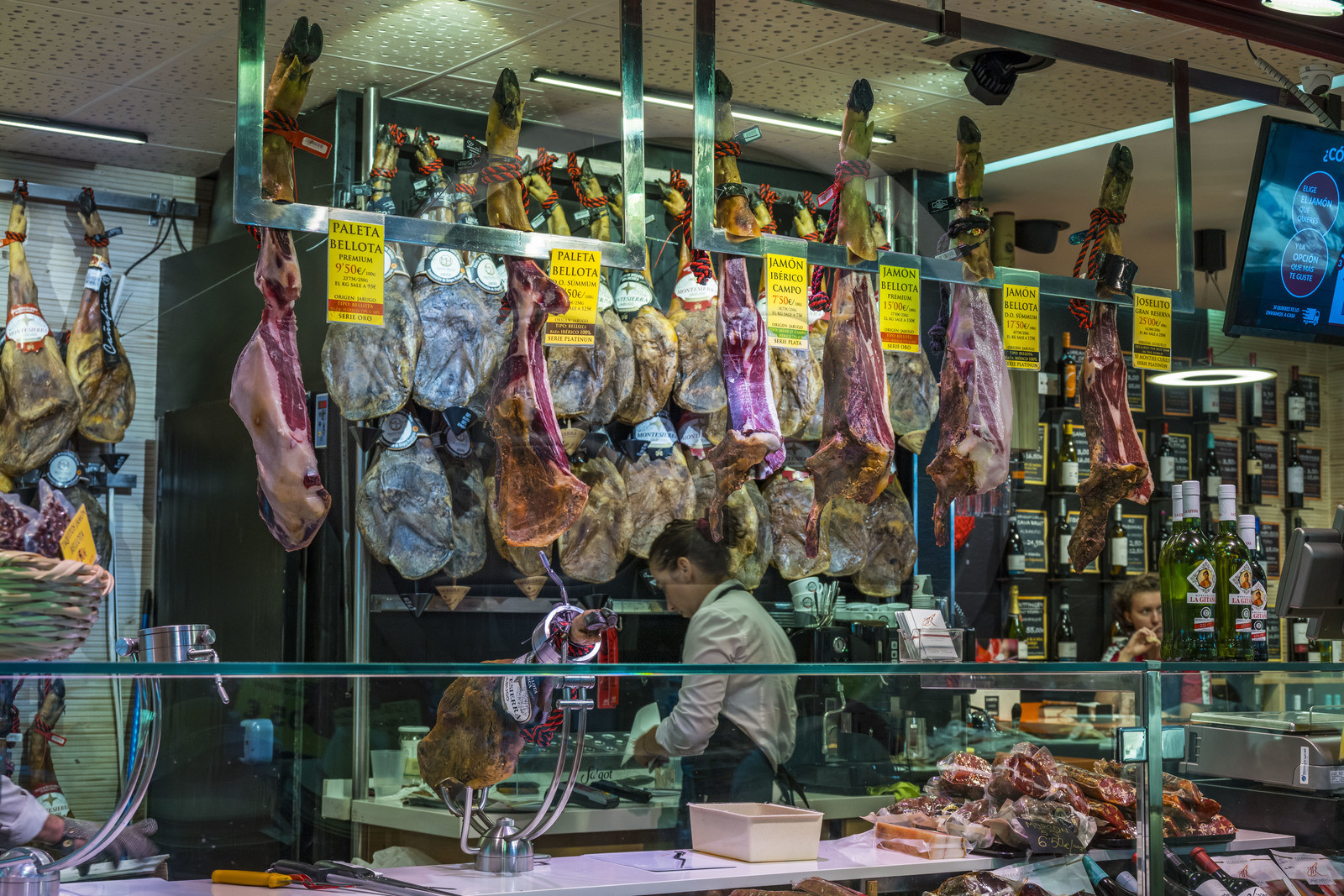 Spain, Andalusia, Seville, Triana district, Triana covered market, butcher stall, cutting ham