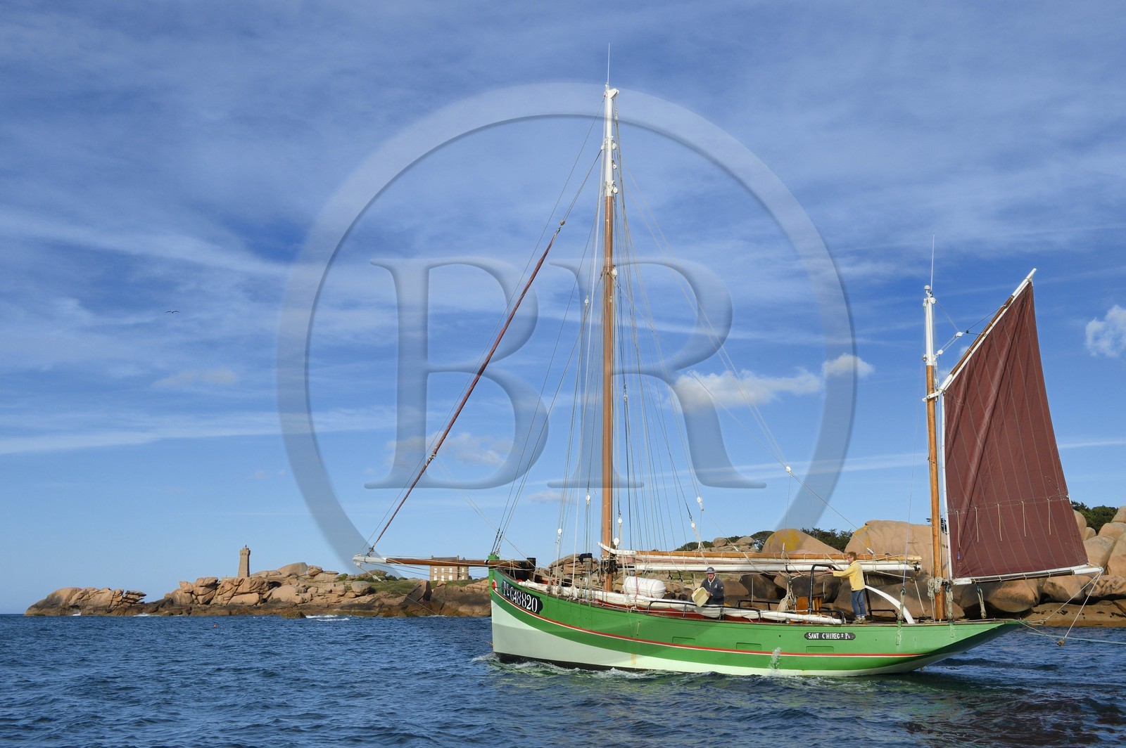 France, Cotes-d'Armor, Cote de Granit Rose (the Pink Granite coast), Perros Guirec, Ploumanach, Pointe de Squewel and Mean Ruz Lighthouse, the traditional sailboat Sant C'hireg (Saint Guirec)