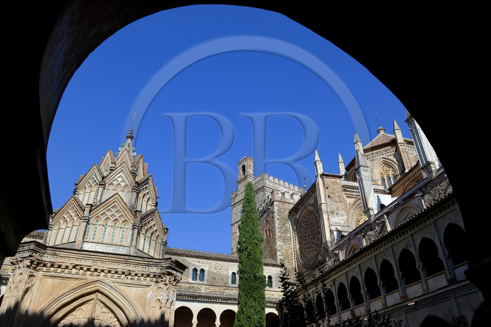 Spain, Extremadura, Guadalupe, Royal Monastery of Santa Maria de Guadalupe listed as World Heritage by UNESCO, Mudejar cloister built in the 15th century and the church in the background