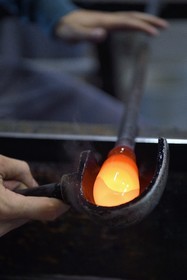 France, Moselle, Meisenthal, Centre international d'Art verrier (CIAV) (international glass centre), the blowing workshop, crafting a Christmas ball, the prompter regulates the mass at home plate while performing a continuous rotation of his cane
