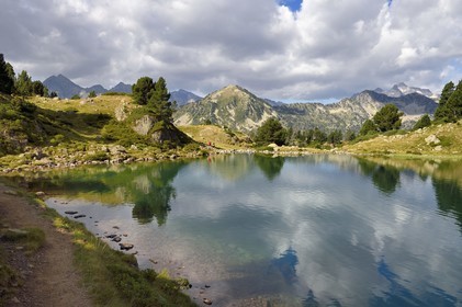 France, Hautes Pyrenees, Saint Lary Soulan and Vielle-Aure, hike on a variant of the GR10 between the Portet pass and the Bastan lakes on the edge of the Neouvielle nature reserve, lower Bastan lake and the Neouvielle massif in the background
