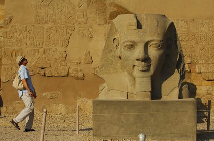 Egypt, Upper Egypt, Nile Valley, Luxor Temple listed as World Heritage by UNESCO, head of Ramesses II in front of the first pylon