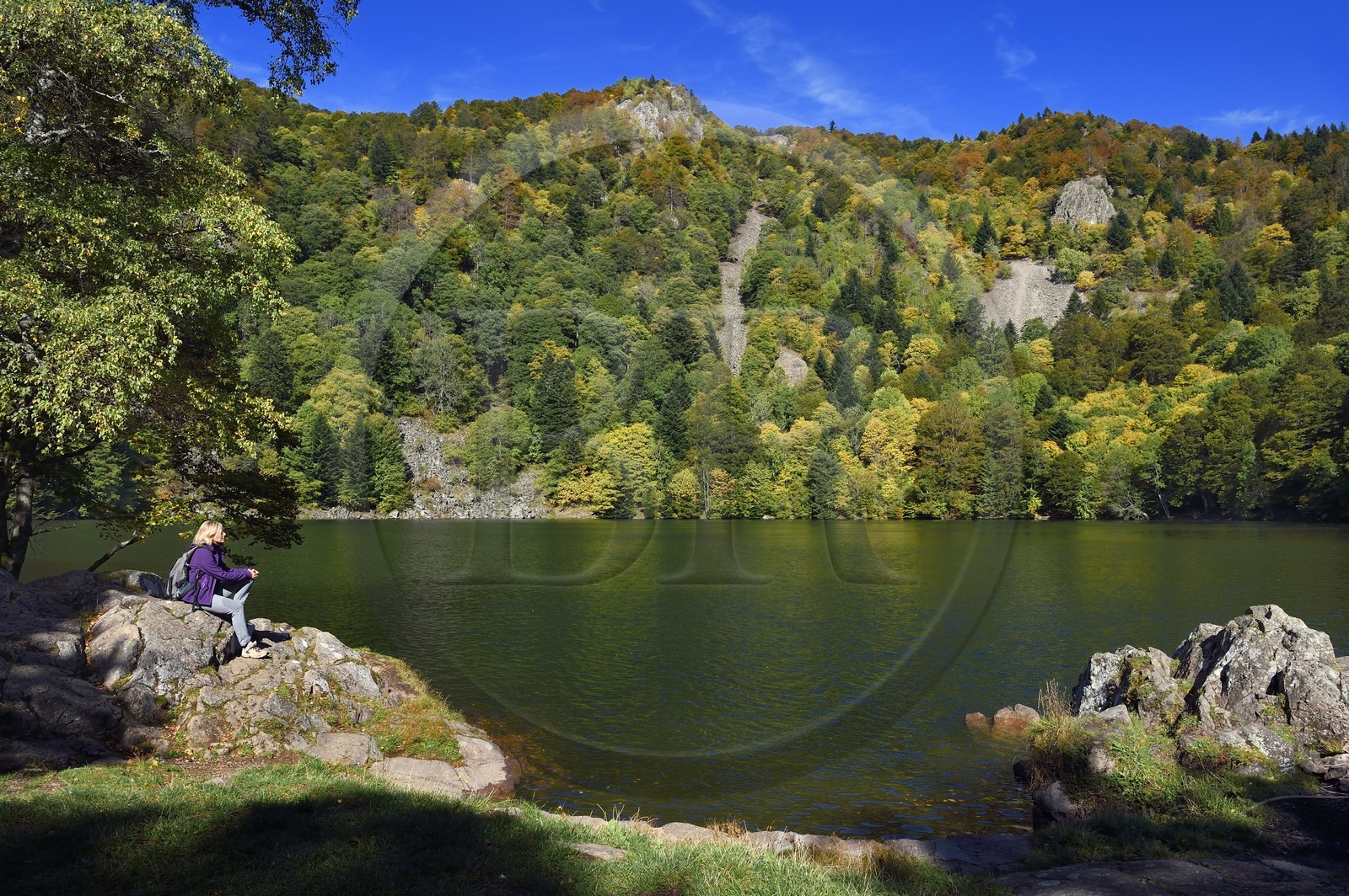 France, Haut Rhin, Ballons des Vosges Regional Natural Park, Rimbach pres Masevaux, hiker at the Lac des Perches under Gazon Rouge in the Vosges
