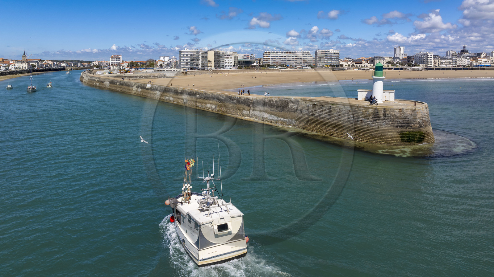 France, Vendee, Les Sables d'Olonne, the channel entrance beacon at the end of the the Jetty of the classified skippers of the Vendée Globe race and fishing boat incoming in the access channel to the ports (aerial view)
