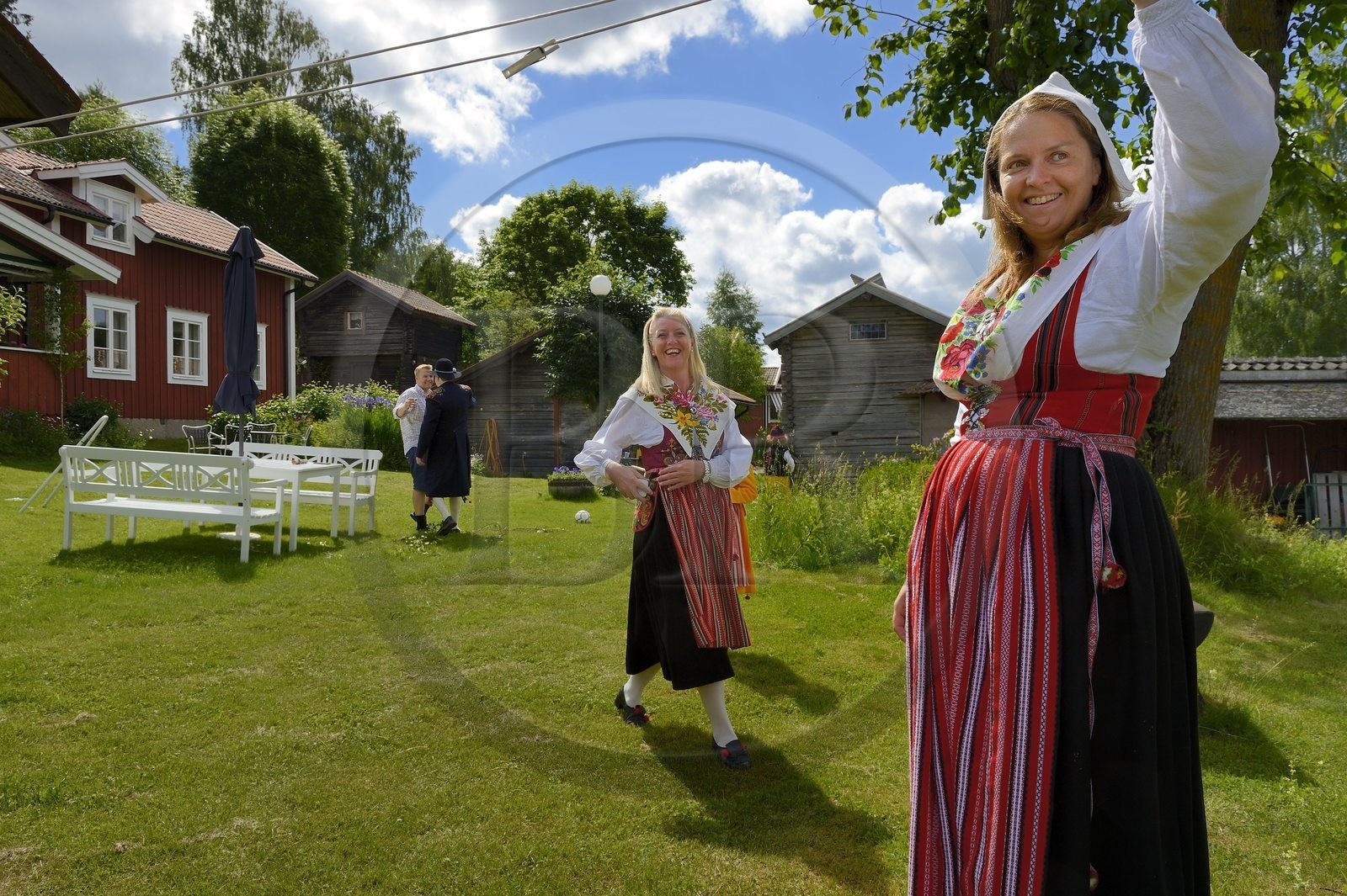 Sweden, Dalarna County, Leksand area, family in traditional costumes for the Midsummer celebrations in the tiny hamlet of Sunnanäng