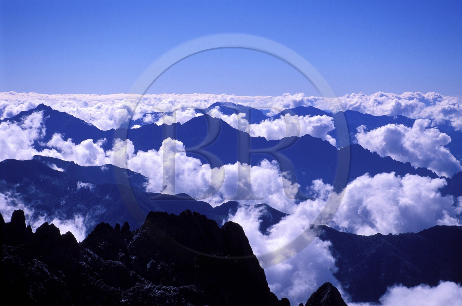 France, Haute Corse, Corsican Mountains appearing from Clouds (Aerial View)