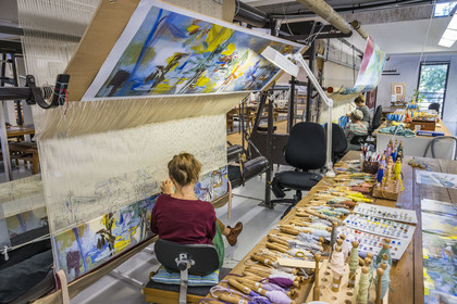 France, Herault, Lodève, Manufacture de la Savonnerie (Savonnerie manufactory) unique annex of the National Carpet Factory of the Savonnerie des Gobelins in Paris, realization by the weaver Kristell Corbinais on a loom of a seat tapestry for the bench L'Iris dans la vallée designed by Philippe Borderieux
