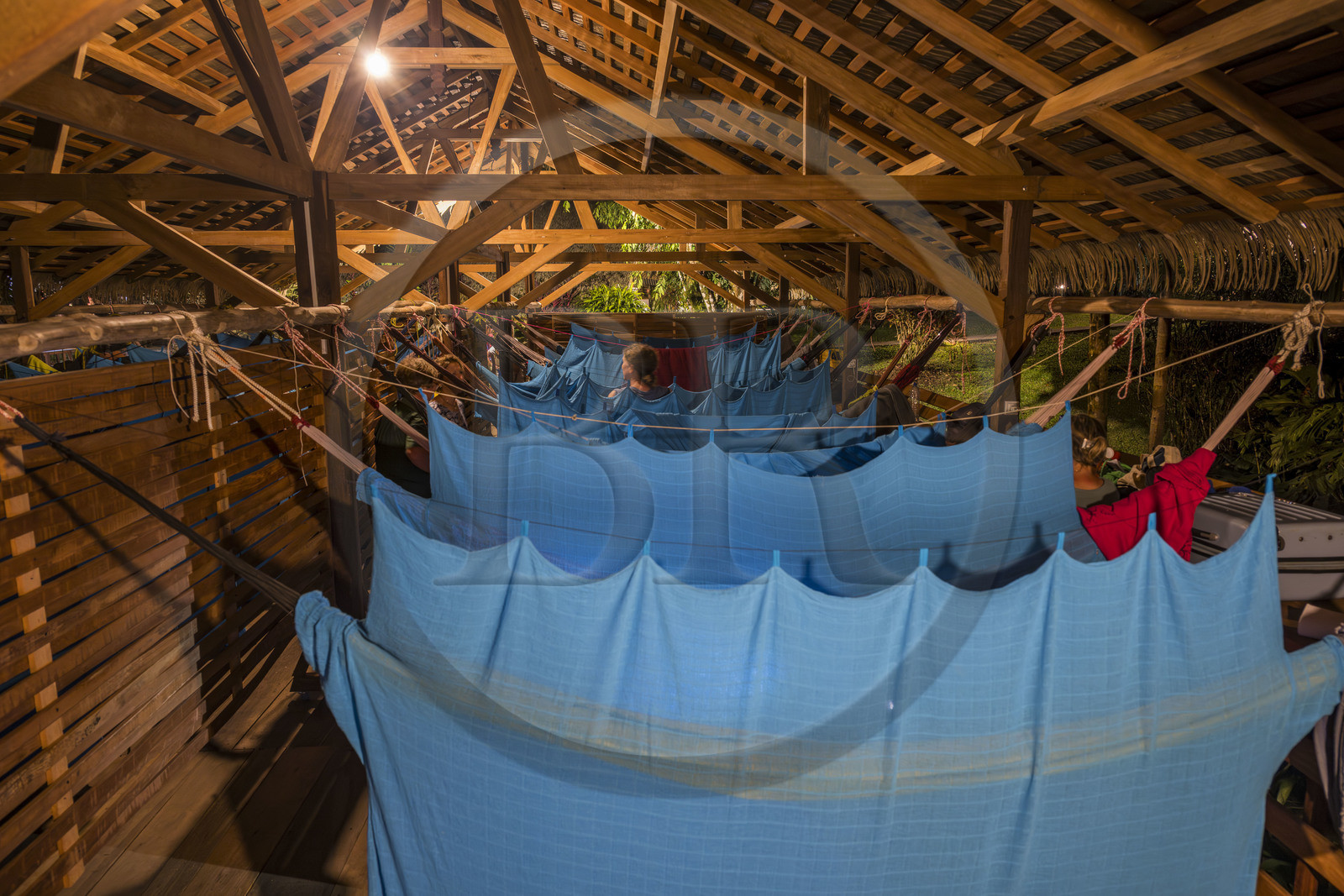 France, French Guiana, Kourou, the carbet (shelter) at Camp Maripas on the banks of the Kourou river, hammocks suspended under the rafters