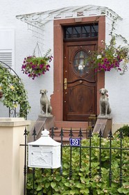 France, Bas Rhin, Northern Vosges Regional Natural Park, Obersteinbach, guard dogs statues in front of a house
