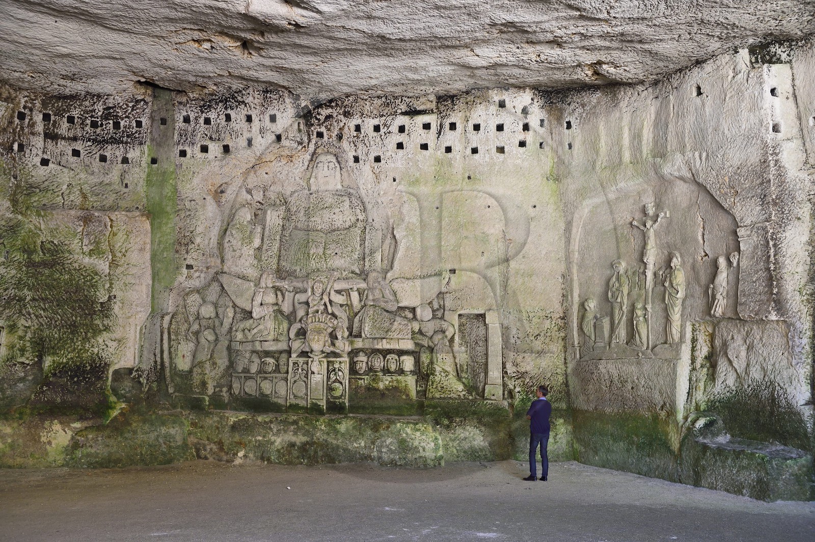 France, Dordogne, Brantome, Saint Pierre benedictine abbey, remains of the first monastery built in the foot of the cliff the cave including the Last Judgement, right Crucifixion from the early 17th century, left bas relief of the fifteenth century under the pigeonholes