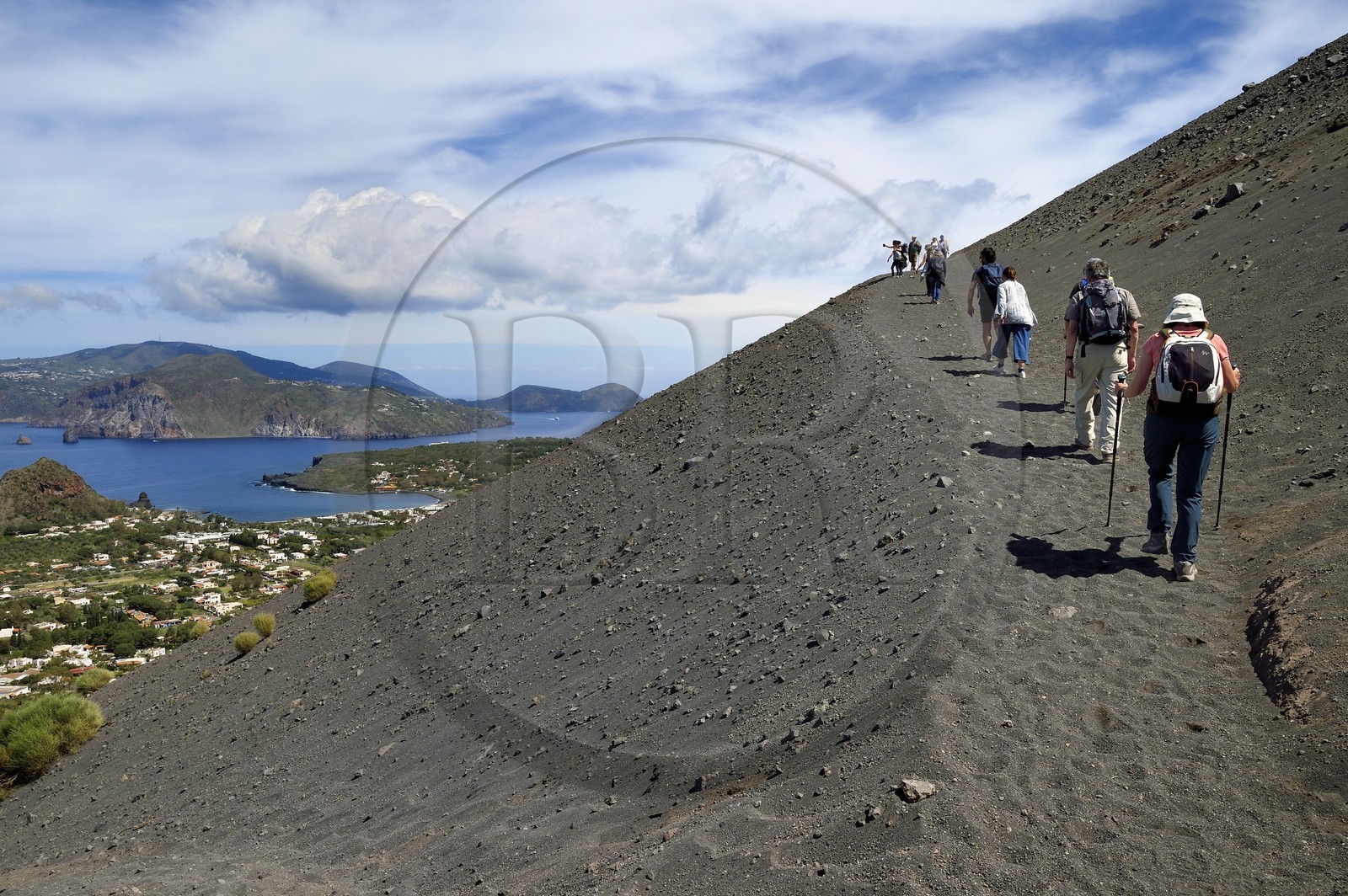 Italy, Sicily, Aeolian Islands, listed as World Heritage by UNESCO, Vulcano Island, hikers climbing the crater of volcano della Fossa, Lipari Island in the background