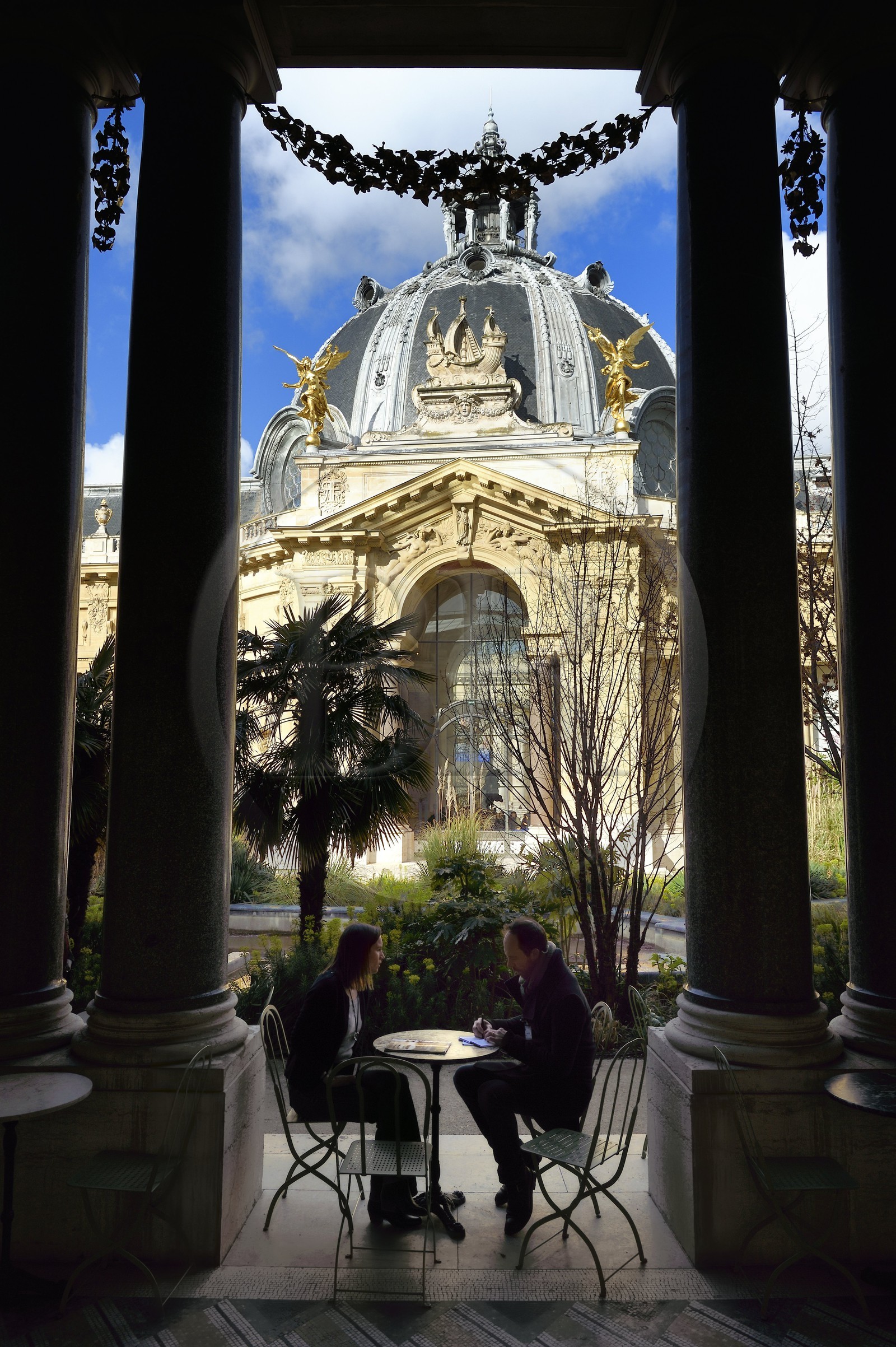 France, Paris, the Petit Palais, built on the occasion of the Universal Exhibition of 1900 by architect Charles Girault, the dome of the main entrance seen from the gardens and the Café under the columns in the garden