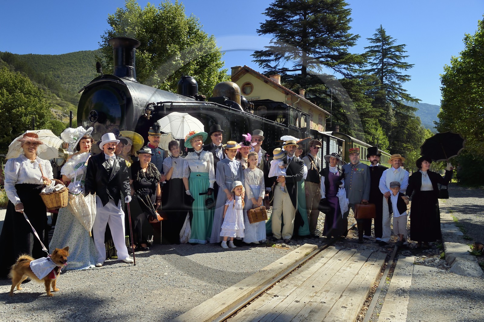 France, Alpes-Maritimes, Puget Theniers, the Train des Pignes historic train, members of the AHVAE (Association d'histoire vivante et de d'archeologie expérimentale) in Belle Epoque costume in front of the steam engine