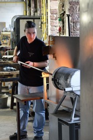 France, Moselle, Meisenthal, Centre international d'Art verrier (CIAV) (international glass centre), the blowing workshop, crafting a Christmas ball, the blower collects a mass of molten glass from the furnace, with his glassmaker's cane