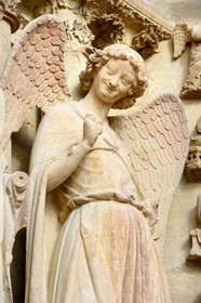 France, Marne, Reims, Notre-Dame de Reims cathedral, listed as World Heritage by UNESCO, detail of the sculpture depicting L'ange au sourire (the Angel with the Smile) on the West Facade