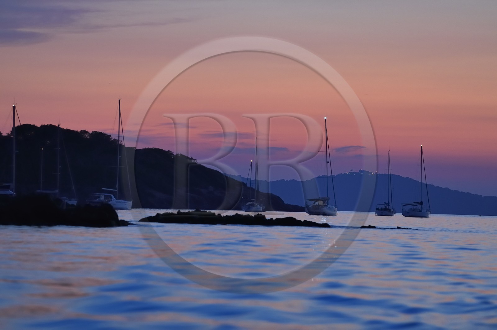 France, Var, Iles d'Hyeres, Parc National de Port Cros (National park of Port Cros), Porquerolles island, boats at anchor at dusk, the Giens peninsula in the background