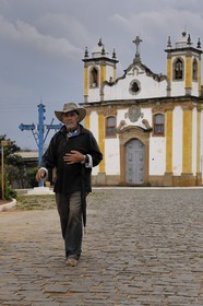 Brazil, Minas Gerais state, Itatiaia village, man outside the church (Gold Route, Estrada Real)