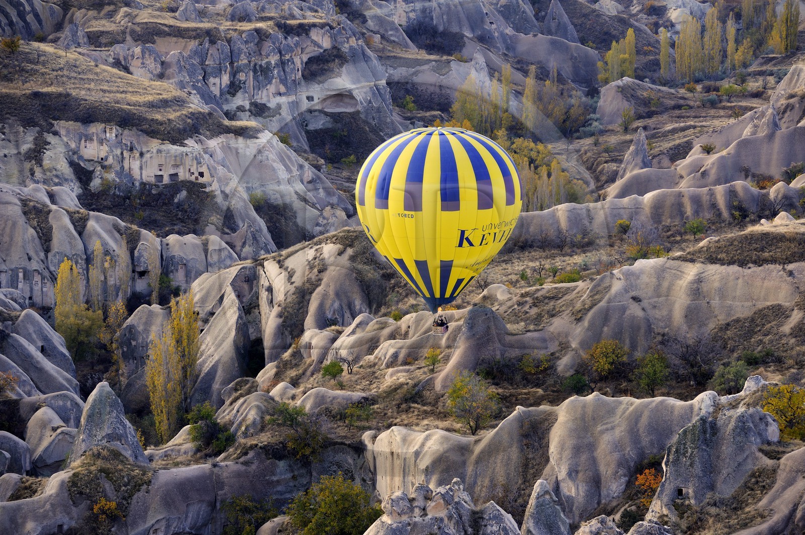 Turkey, Central Anatolia, Nevsehir Province, Cappadocia listed as World Heritage by UNESCO, hot air baloon flying over Balkan Valley in Ortahisar (aerial view)
