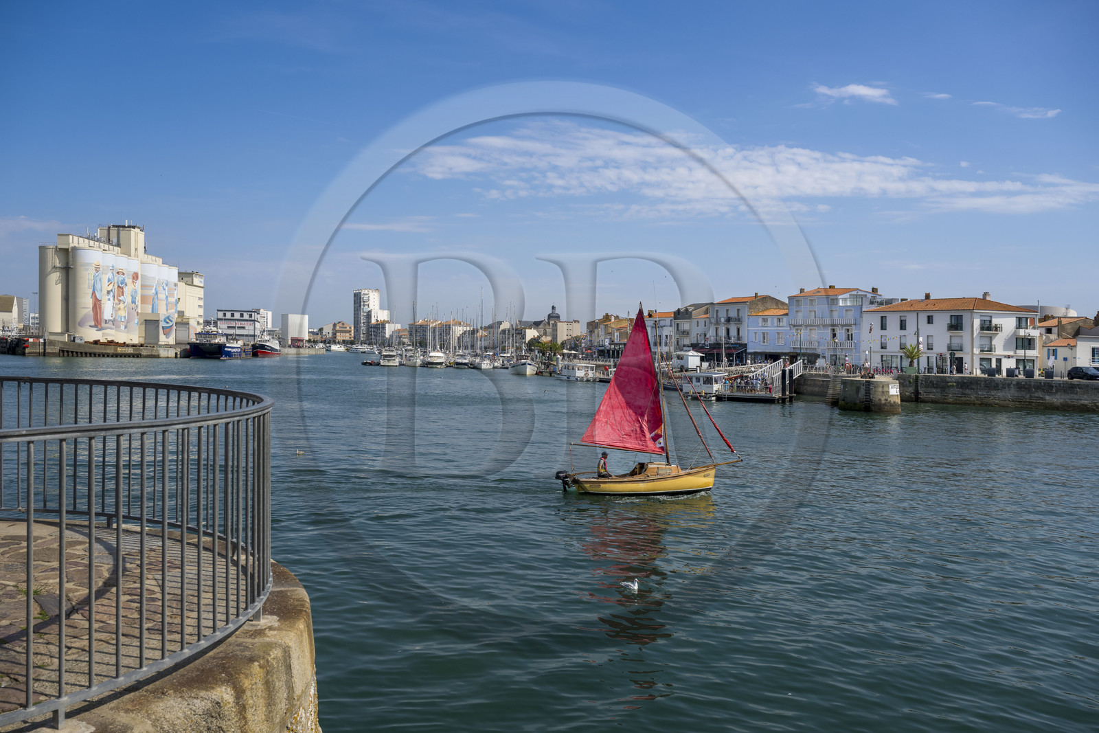 France, Vendee, Les Sables d'Olonne, traditional sailboat leaving the port, fresco retracing the history of the city painted on the silos of the Cavac cooperative by the Basque artist Taroe in the background