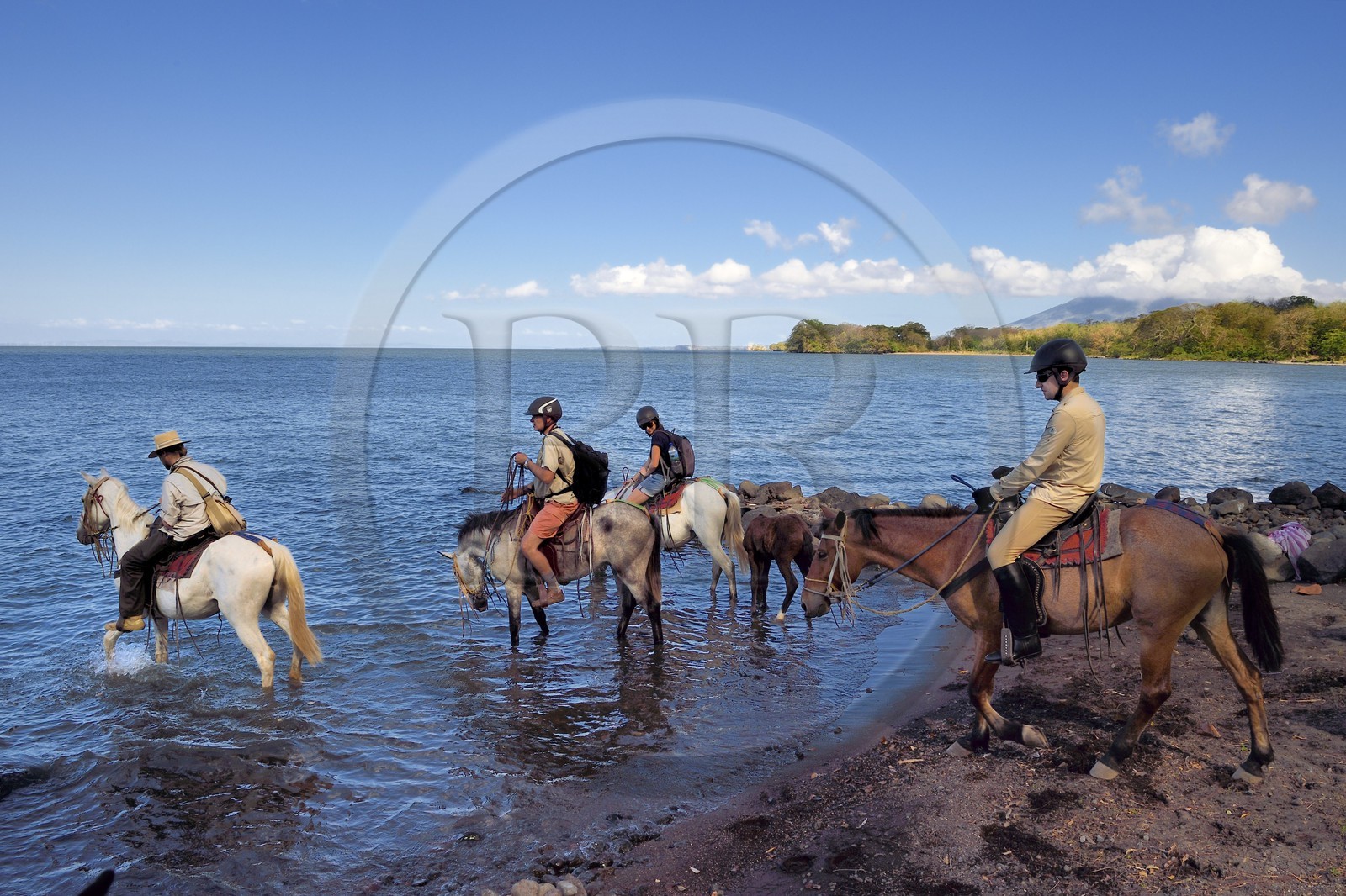 Nicaragua, Ometepe Island in Lake Nicaragua, riders along the lake