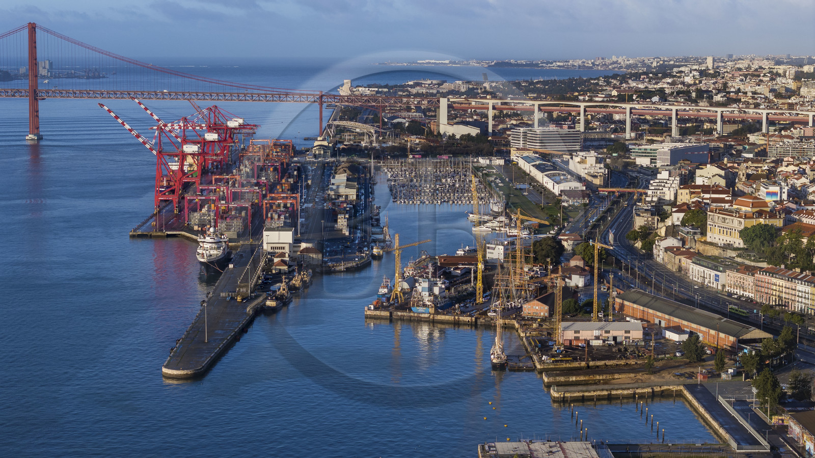 Portugal, Lisbon, Lisbon port and the Doca de Alcantara on the banks of the Tagus, the Ponte 25 de Abril in the background (aerial view)