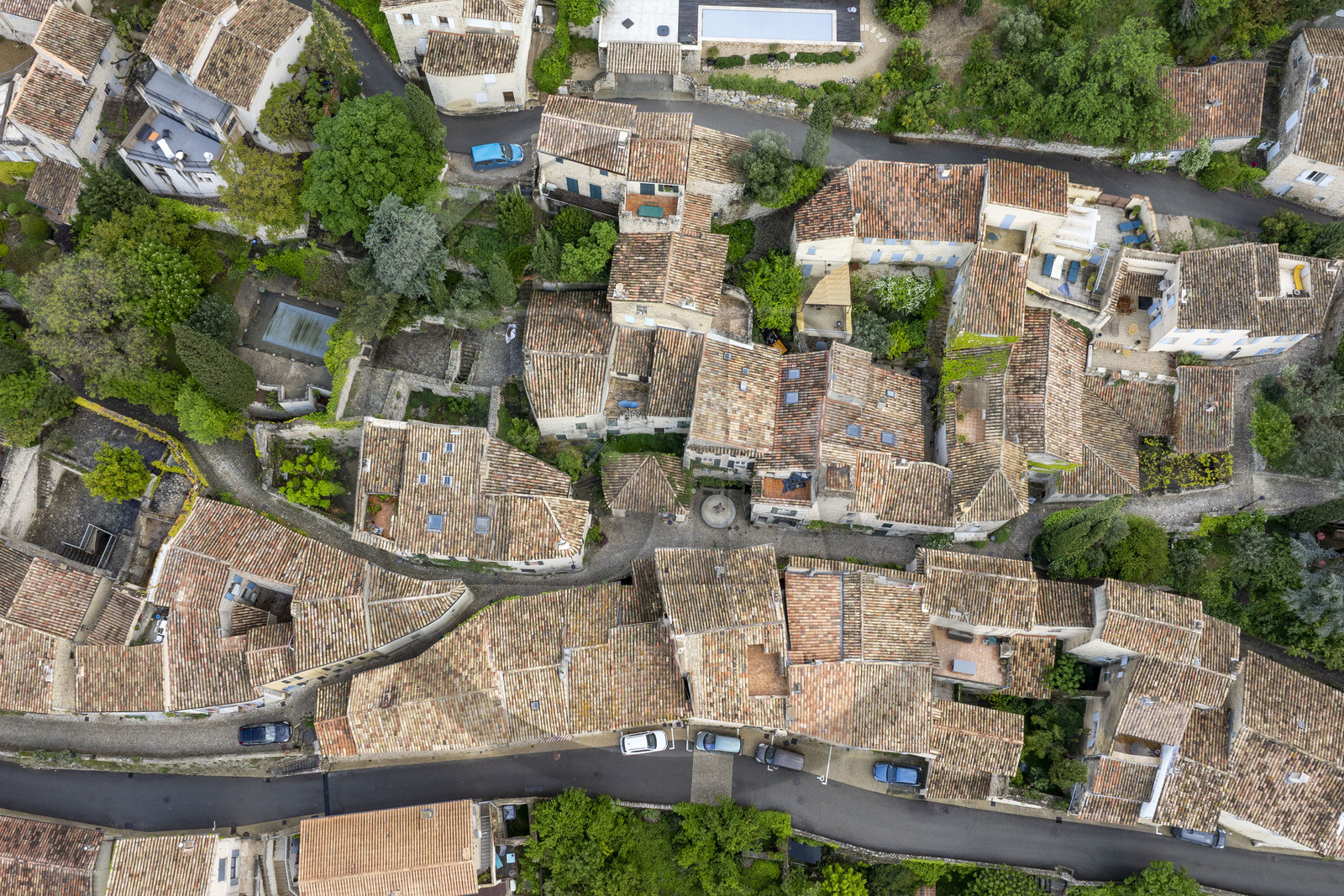 France, Vaucluse, Dentelles de Montmirail mountains, the medieval village of Séguret, labelled Les Plus Beaux Villages de France (The Most Beautiful Villages of France), the Mascarons fountain in the rue des Poternes which crosses the village from North to South (aerial view)