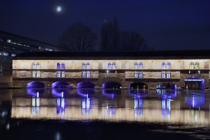 France, Bas Rhin, Strasbourg, old town listed as World Heritage by UNESCO, la Petite France District, Vauban dam and bridge on the Ill river, illuminations in the evening