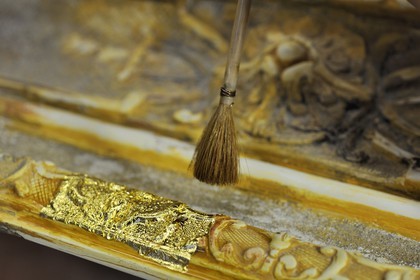 France, Yvelines, Chateau de Versailles, the castle restoration workshop, gilt workshop, Laurent Hissier working on a frame