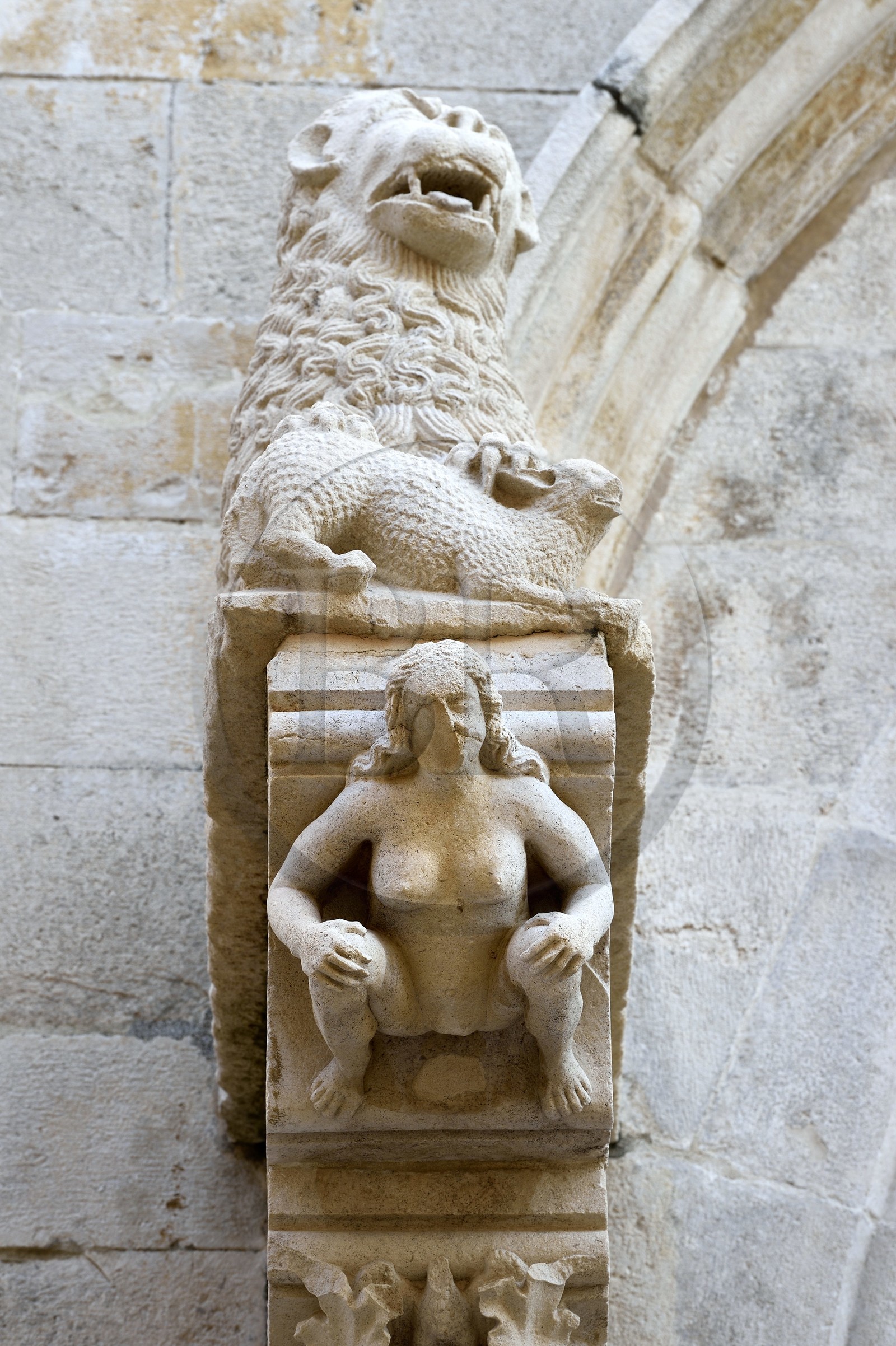 Croatia, Dalmatia, Korcula Island, Korcula Town, detail of the central portal of the St. Mark's Cathedral, sculpture of Eve under a lion on the main facade