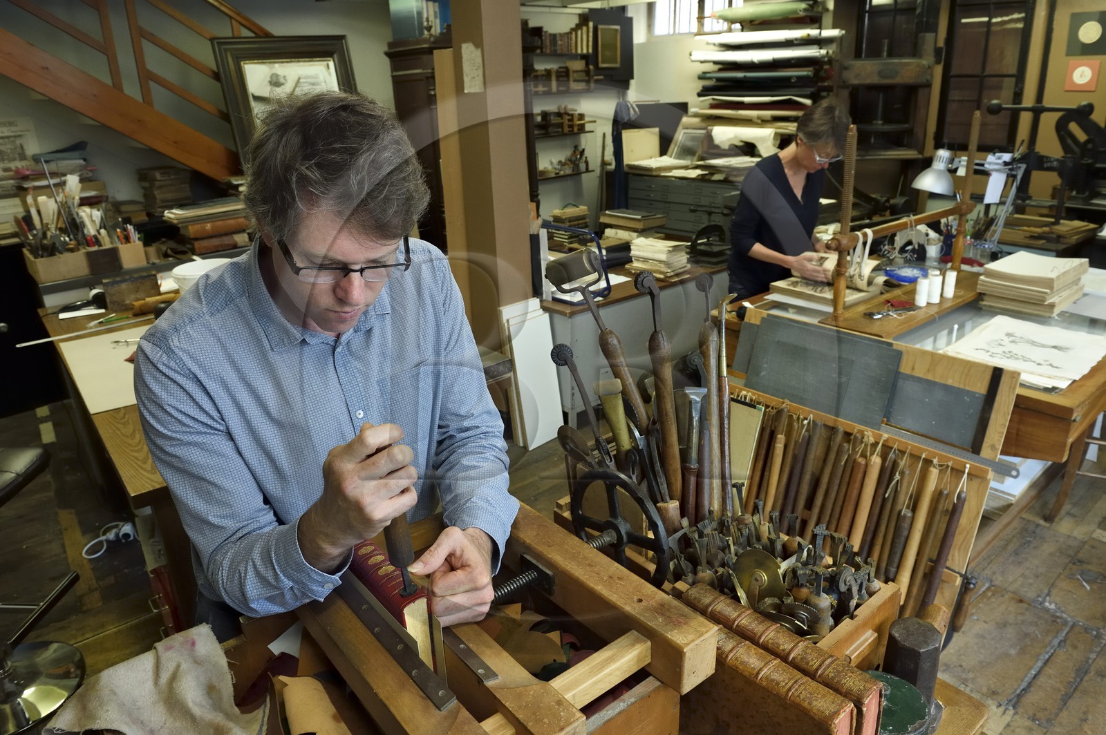 France, Dordogne, White Perigord, Perigueux, Christophe and Nathalie Legrand in their art bindery, foil and cardboard workshop