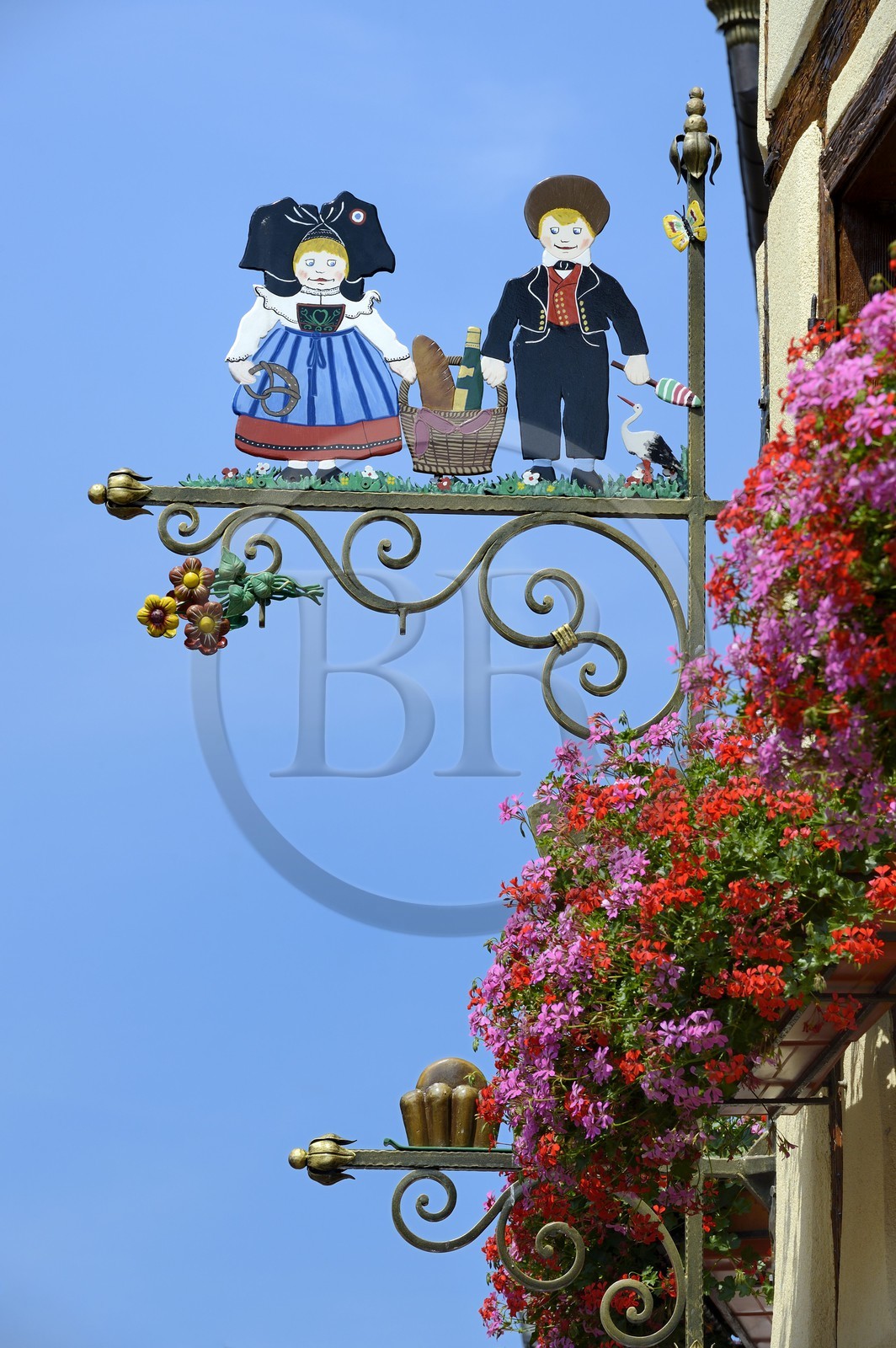 France, Haut Rhin, Eguisheim, labelled Les Plus Beaux Villages de France (The Most Beautiful Villages of France), baker sign with characters in typical outfit from Alsace