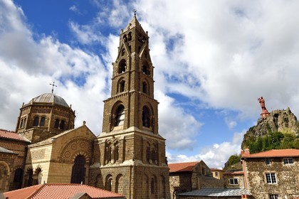 France, Haute Loire, Le Puy en Velay, Routes of Santiago de Compostela, the 12th century Our Lady (Notre-Dame-de-l'Annunciation) cathedral listed as World heritage by UNESCO, the statue of Notre-Dame de France (from 1860) at the top of Rocher Corneille in the background