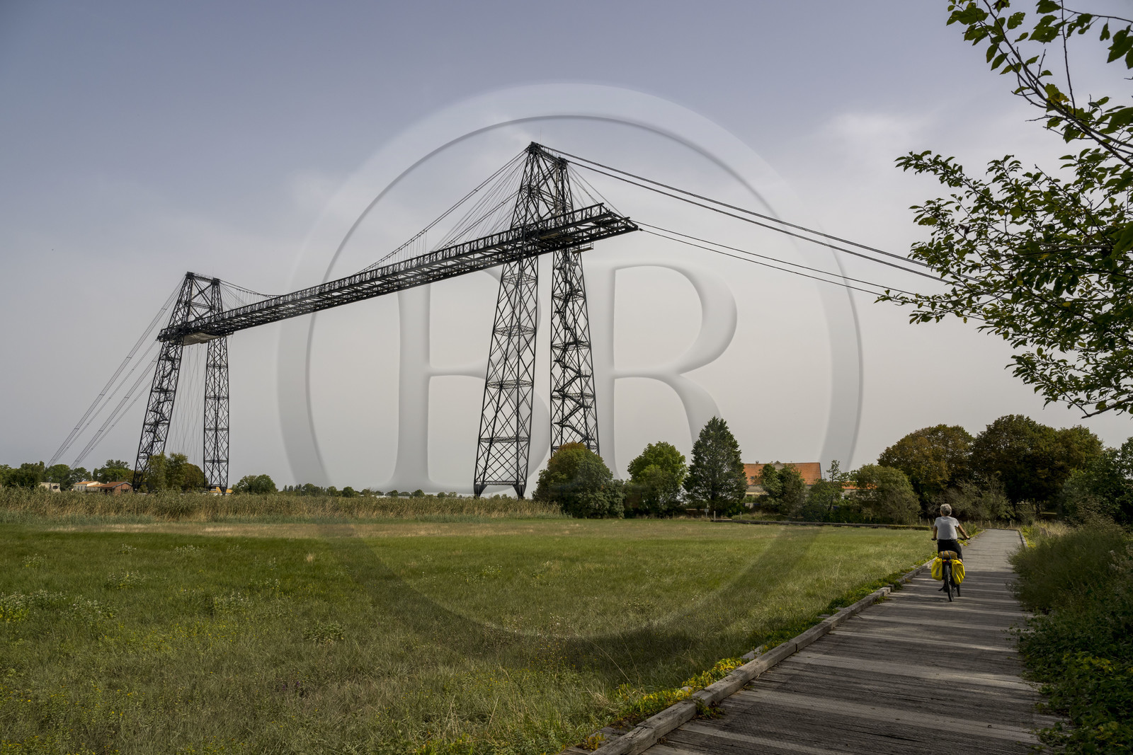 France, Charente Maritime, Rochefort, the Rochefort (or Martrou) transporter bridge built by Ferdinand Arnodin in 1900, cyclist along the cycle route