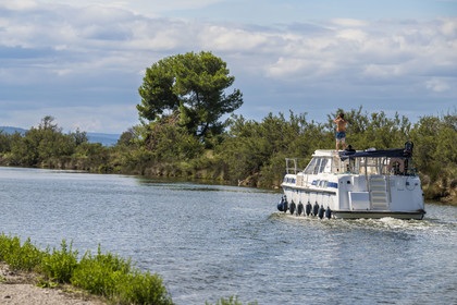 France, Herault, La Grande-Motte, navigation of a pleasure boat on the Rhone to Sète Canal on the edge of the Etang de l'Or