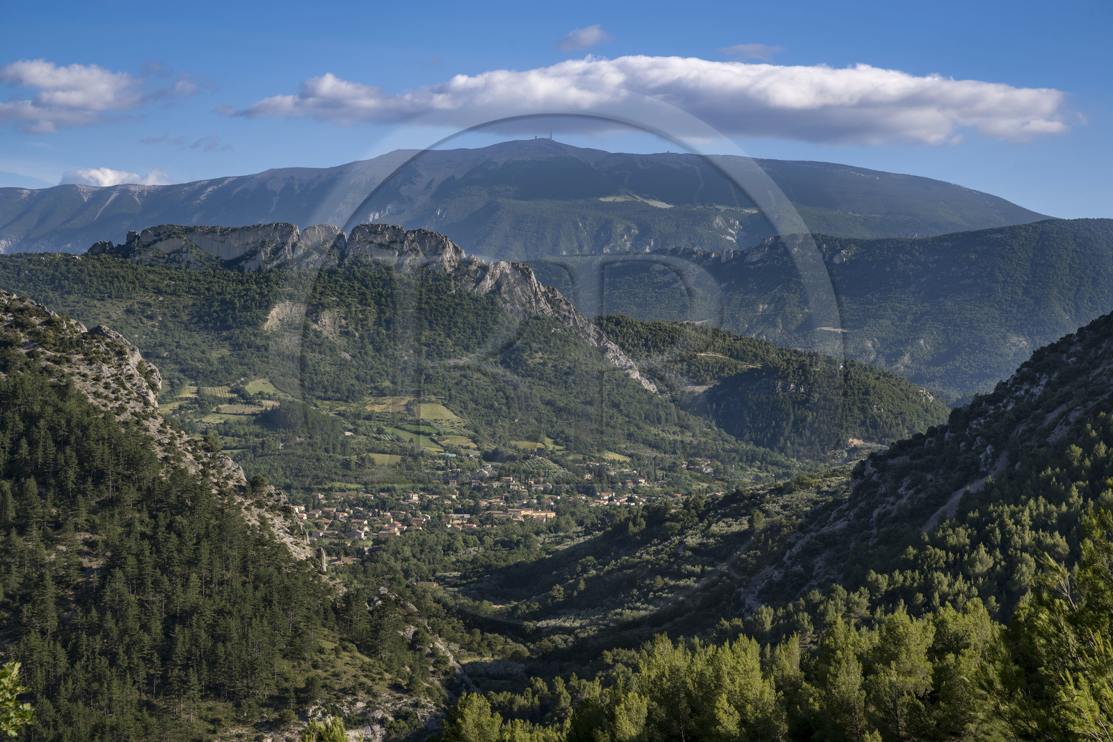 France, Drome, regional natural park of Baronnies provencales, the large limestone blade of the Rocher de Saint-Julien over looking Buis les Baronnies, Mont Ventoux in the background (aerial view)
