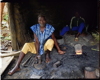 Burkina Faso, Poni province, Lobi land, Loropéni, blacksmith with his apprentice, he is the craftsman who manufactures iron tools (hoes, arrowheads ...) but also forges a strong bond with the world of ancestors