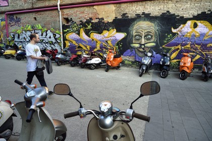 Georgia, Tbilisi, Fabrika hotel cafe, scooters parking and graffiti