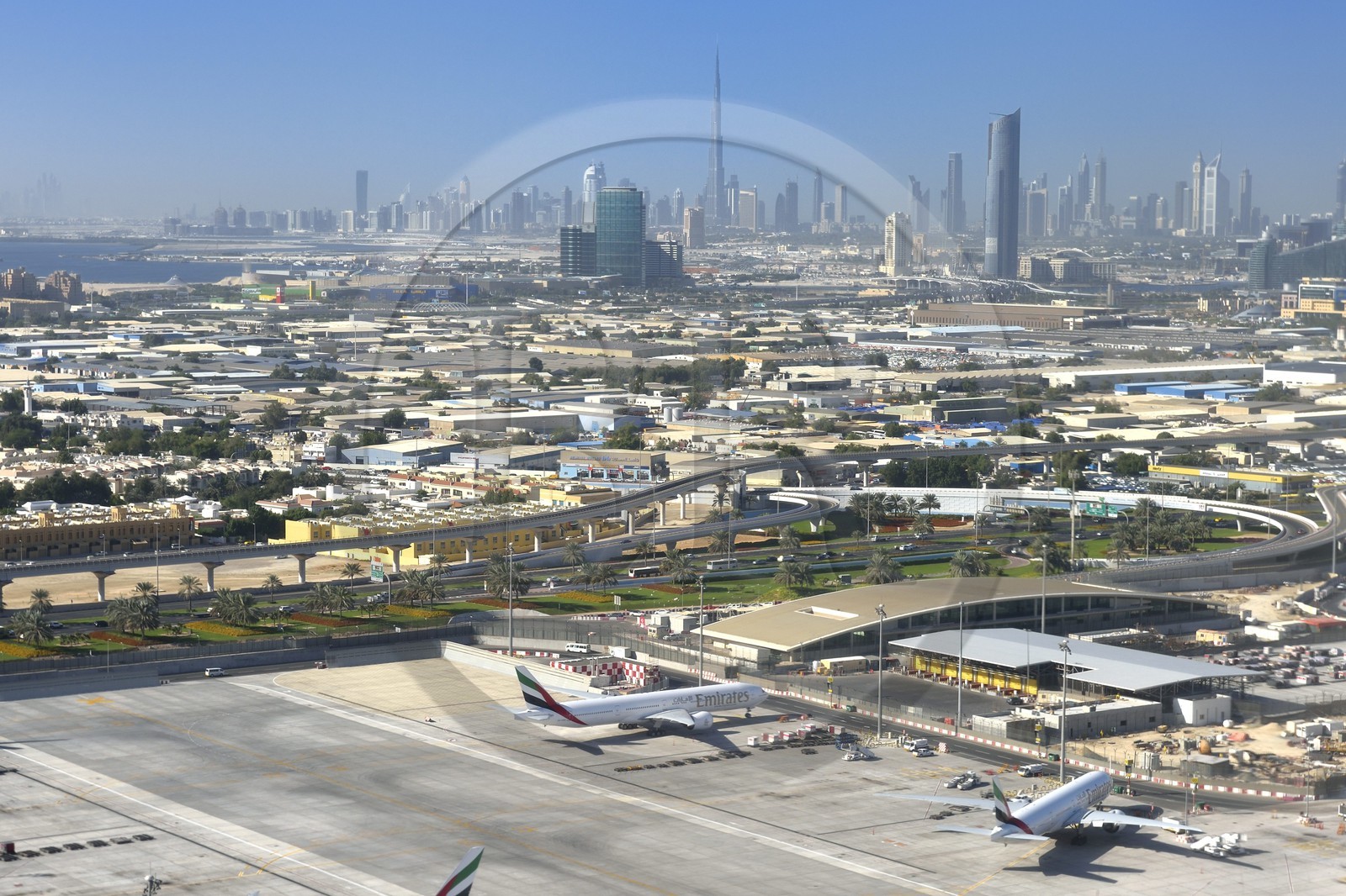 United Arab Emirates, Dubai, Dubai International Airport and the city center in the background (aerial view)